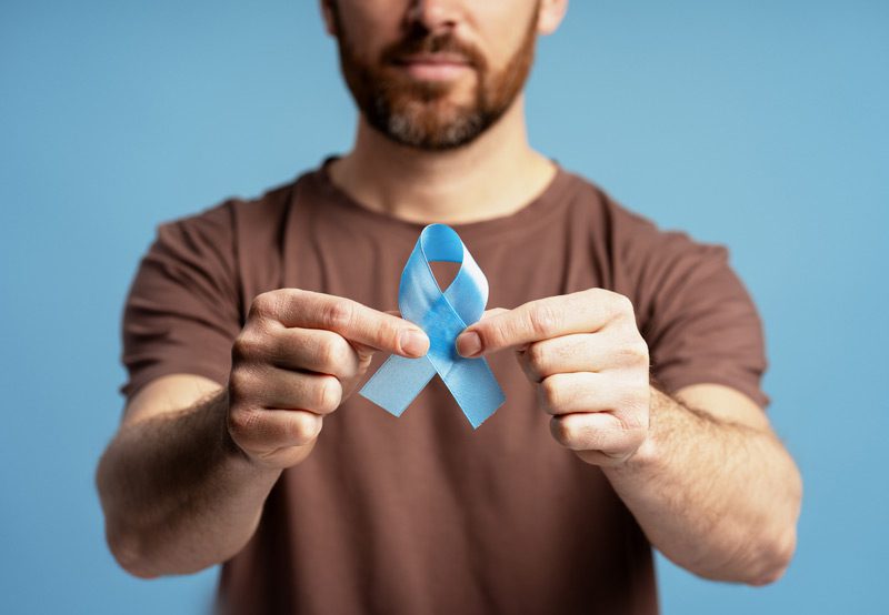 Man-holding-ribbon-for-prostate-cancer-awareness